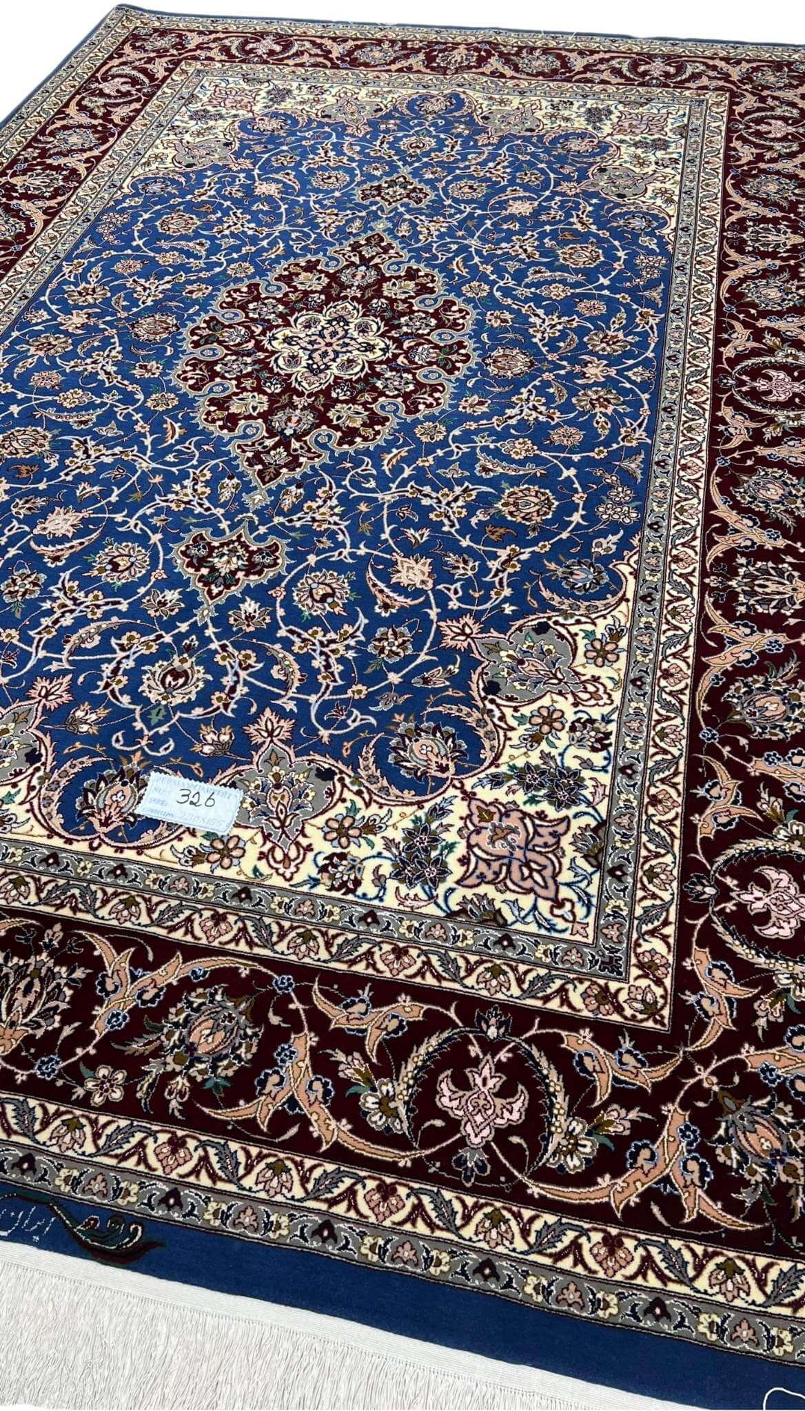 "Royal blue and burgundy Persian rug, crafted with wool and silk, showcasing a classic medallion pattern."
